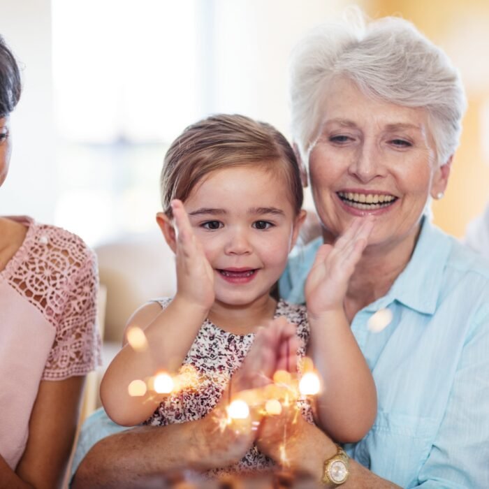 little-girl-lwatching-sparklers-on-a-birthday-cake-2024-09-18-14-00-58-utc-min